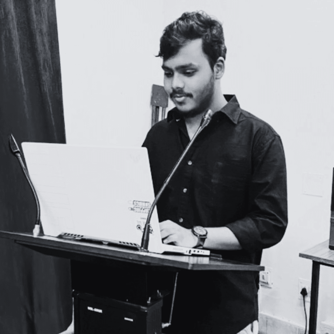 I am standing along a podium with a laptop