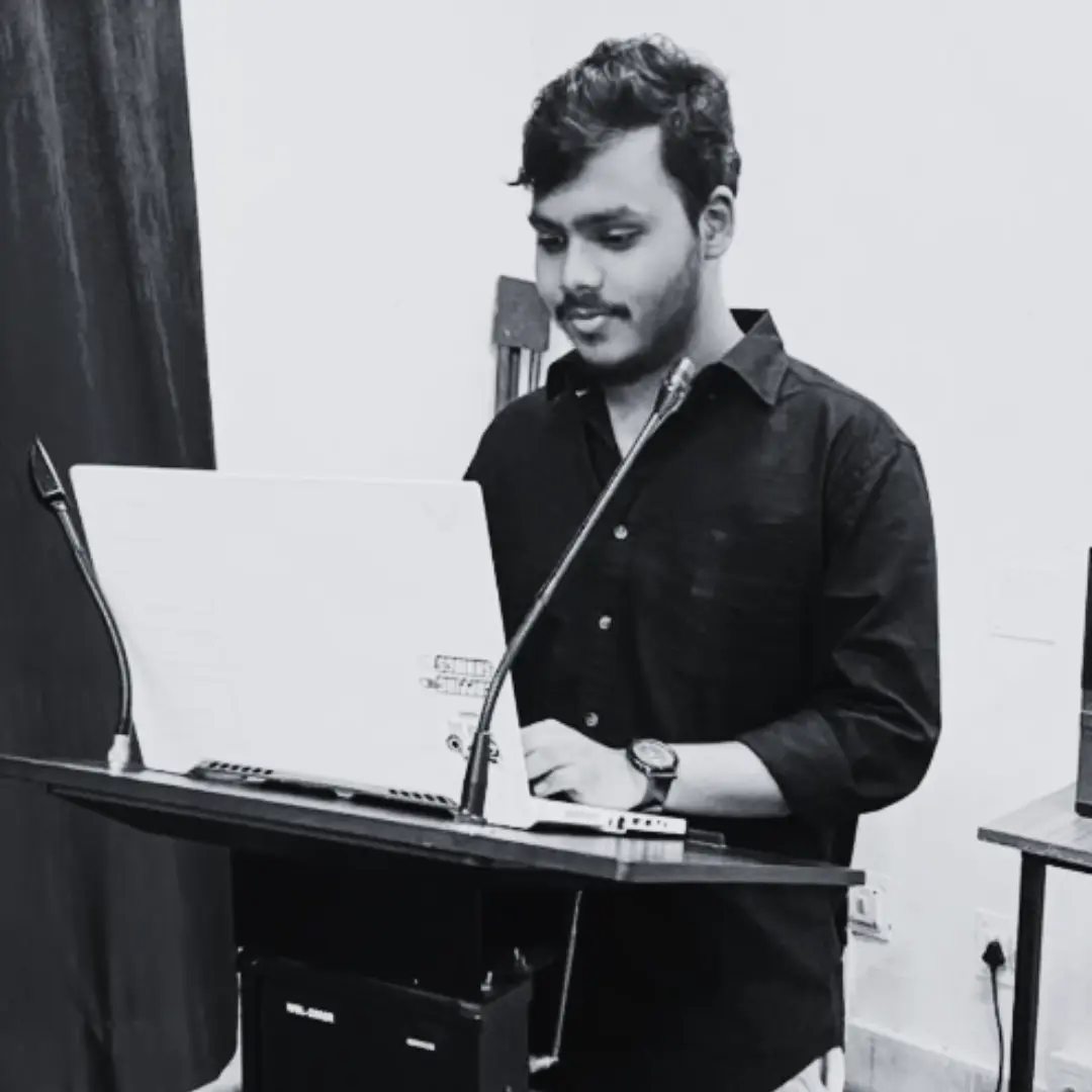 I am standing along a podium with a laptop